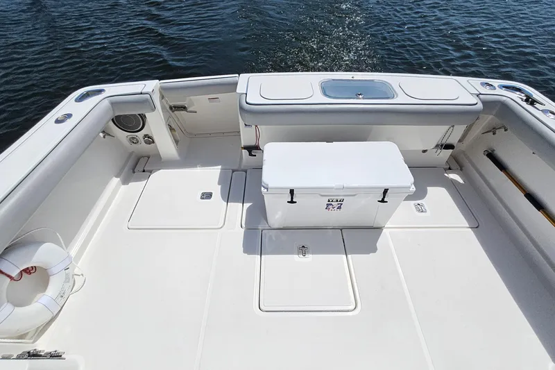 Slide: The Image of 2006 Tiara 3200 Open boat deck with cooler and life preserver on calm water. - 11