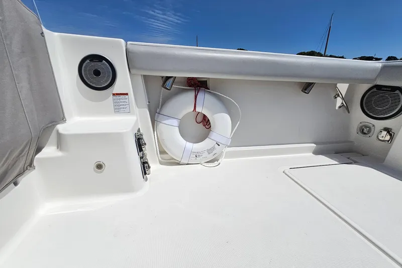 Slide: The Image of 2006 Tiara 3200 Open boat deck with life preserver and speakers under clear sky. - 13