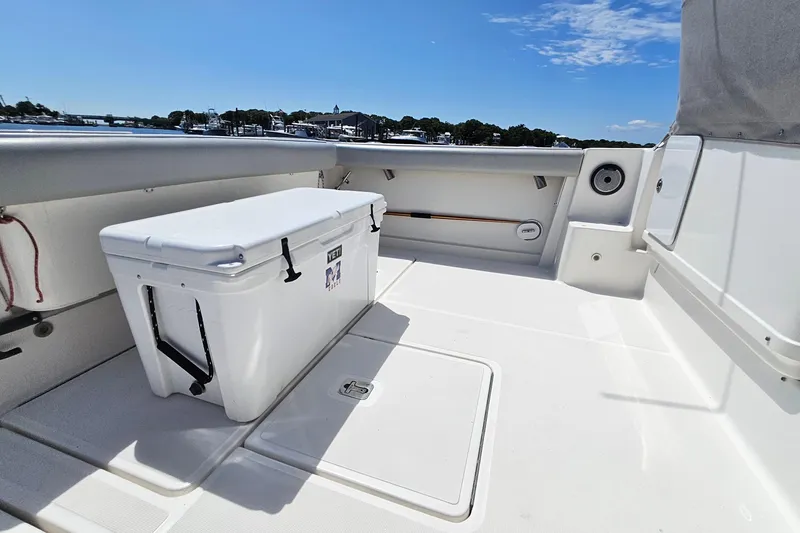 Slide: The Image of 2006 Tiara 3200 Open boat deck with Yeti cooler, under clear blue sky. - 15