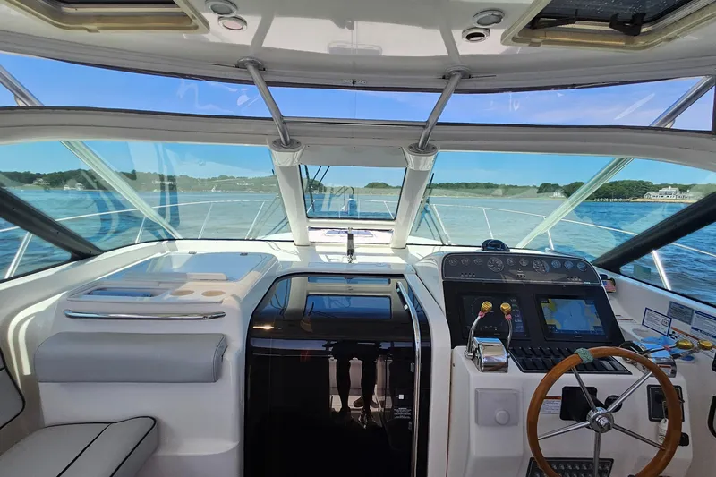 Slide: The Image of Interior view of 2006 Tiara 3200 Open yacht cockpit with steering wheel and navigation controls. - 19