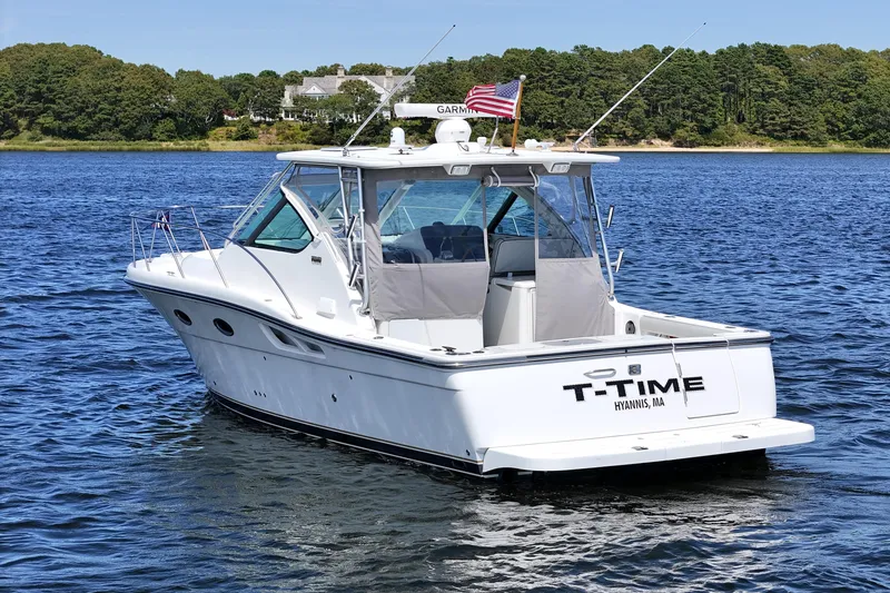 Slide: The Image of 2006 Tiara 3200 Open boat on water, displaying "T-Time" and American flag. - 2
