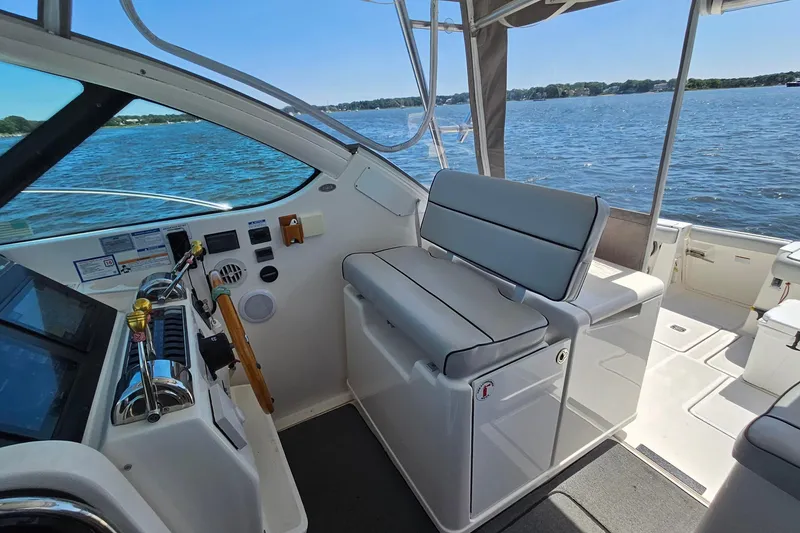 Slide: The Image of 2006 Tiara 3200 Open boat interior with helm and seating, overlooking calm waters. - 22