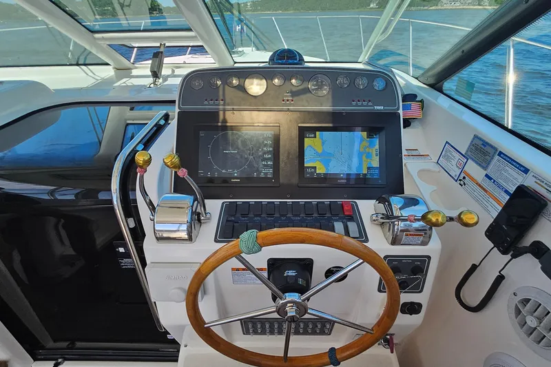 Slide: The Image of Helm of 2006 Tiara 3200 Open boat with navigation screens and wooden steering wheel. - 26