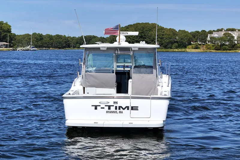 Slide: The Image of 2006 Tiara 3200 Open boat on water, rear view, with American flag. - 3