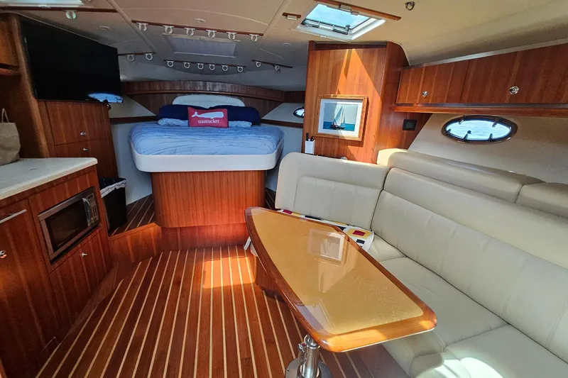 Slide: The Image of Luxurious interior of a 2006 Tiara 3200 Open yacht with cozy seating and elegant wood finishes. - 30