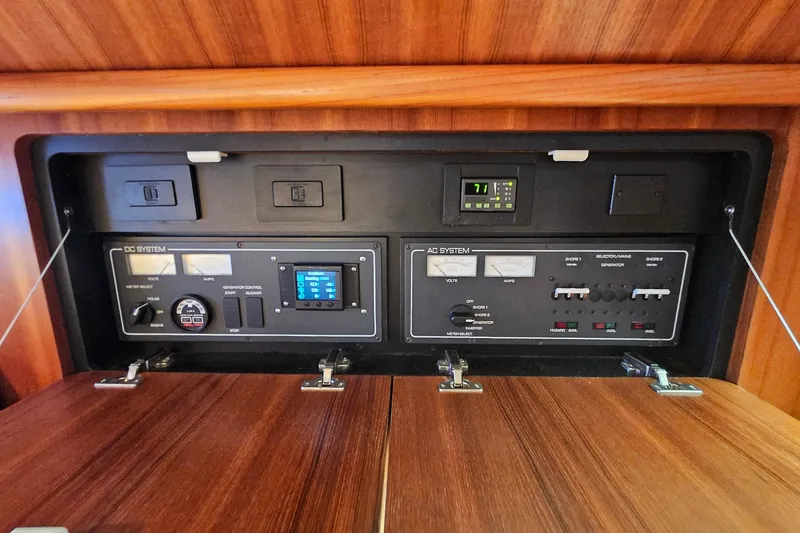 Slide: The Image of Electrical control panel of a 2006 Tiara 3200 Open boat, featuring AC and DC systems. - 33