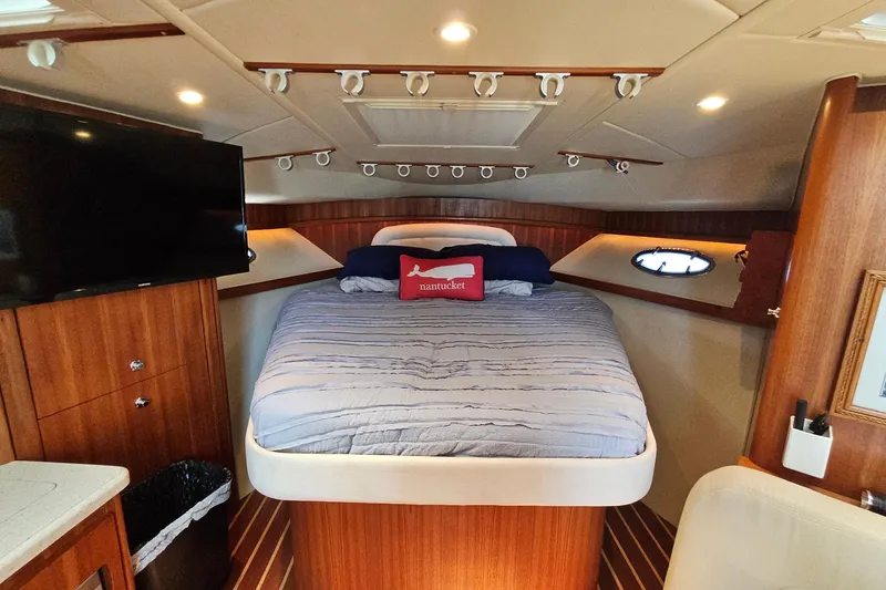 Slide: The Image of Luxurious cabin interior of a 2006 Tiara 3200 Open yacht with cozy bed and modern amenities. - 37