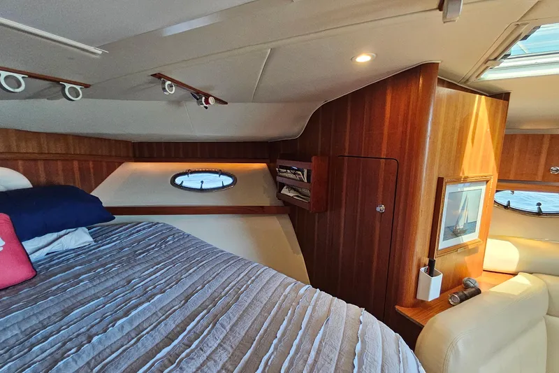 Slide: The Image of Luxurious cabin interior of a 2006 Tiara 3200 Open yacht with wood paneling and cozy bedding. - 39