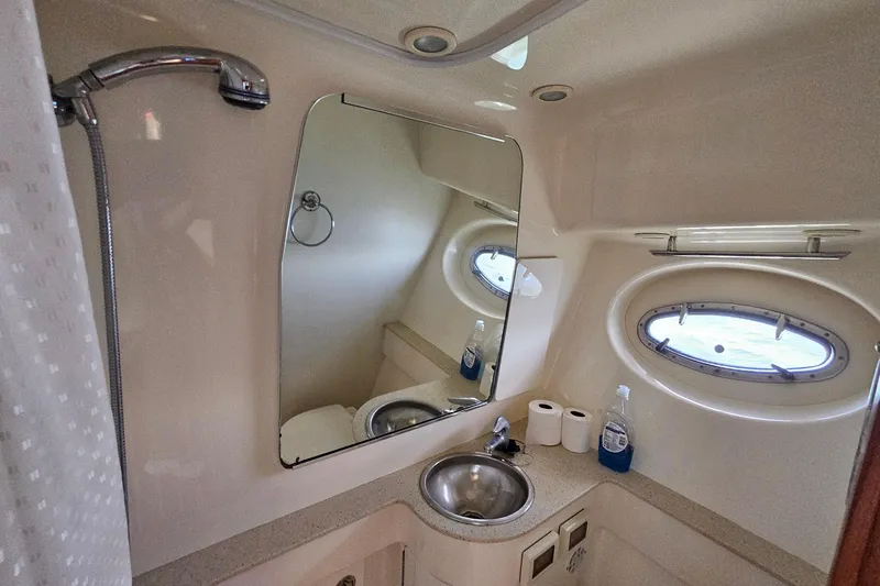 Slide: The Image of 2006 Tiara 3200 Open yacht bathroom with mirror, sink, and porthole window. - 40