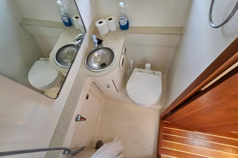 Slide: The Image of Compact bathroom in 2006 Tiara 3200 Open yacht with sink, toilet, and mirror. - 41