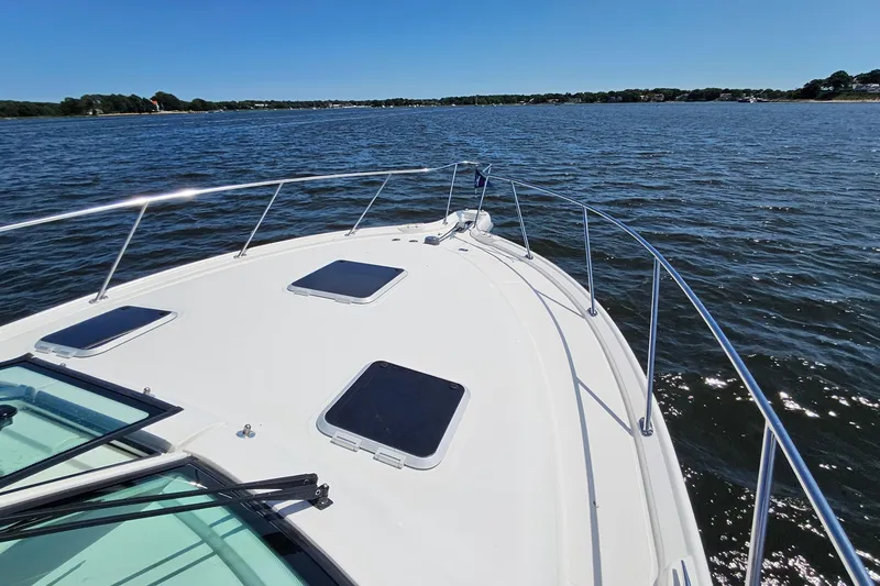 Slide: The Image of 2006 Tiara 3200 Open yacht cruising on a sunny day, showcasing sleek deck design. - 46