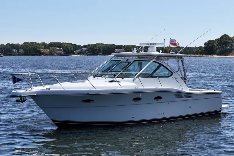 Slide: The Image of 2006 Tiara 3200 Open yacht on calm water, featuring sleek design and American flag. - 5