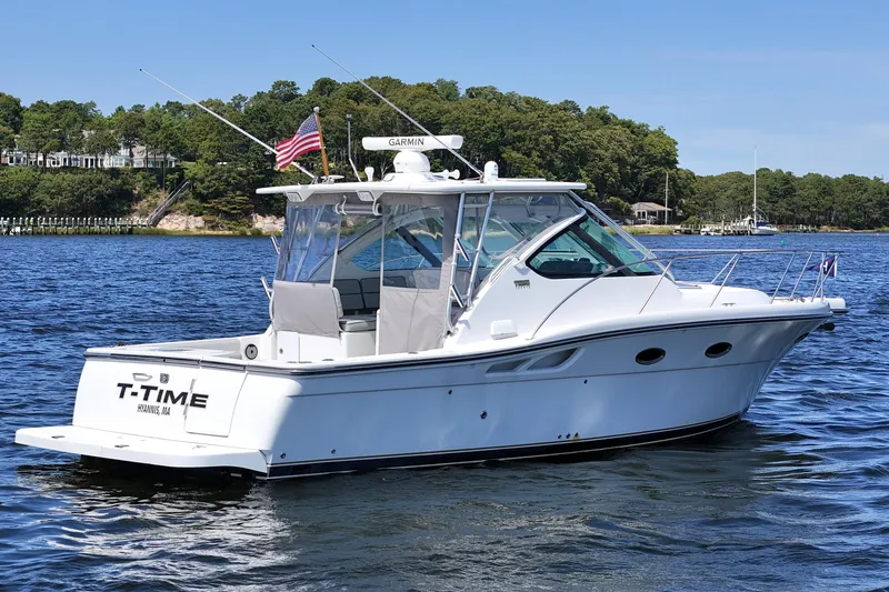 Slide: The Image of 2006 Tiara 3200 Open yacht on water, featuring sleek design and American flag. - 6