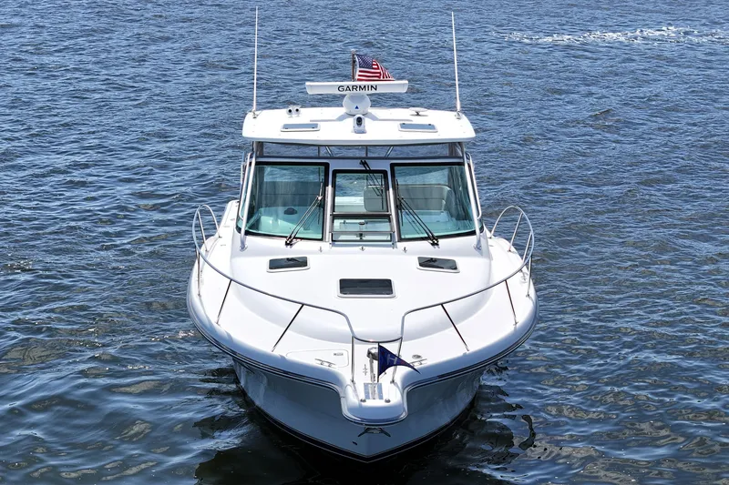 Slide: The Image of 2006 Tiara 3200 Open boat on water, front view with American flag. - 8