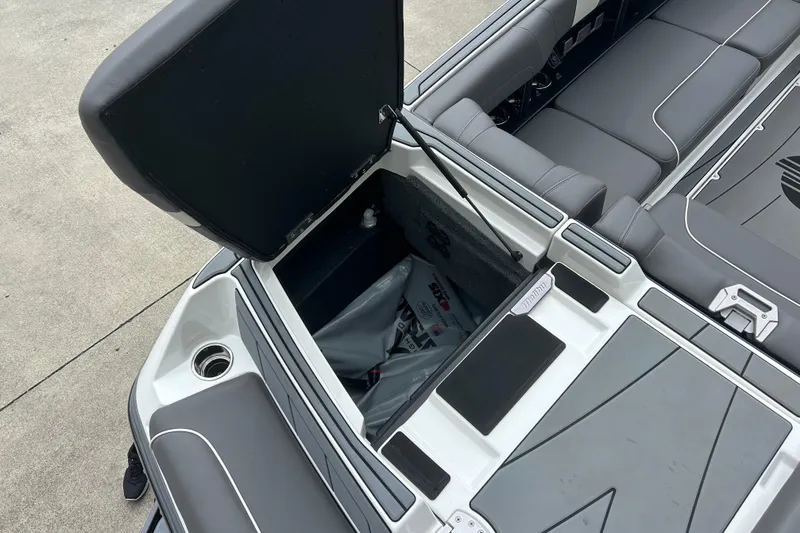 Slide: The Image of 2022 Malibu Wakesetter 23 LSV boat interior with open storage compartment. - 11