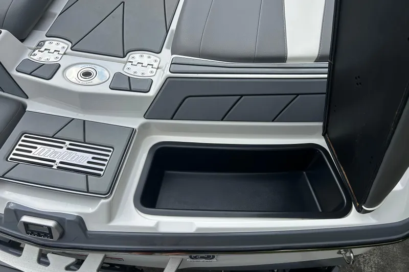 Slide: The Image of 2022 Malibu Wakesetter 23 LSV boat interior with storage compartment and branded detailing. - 13
