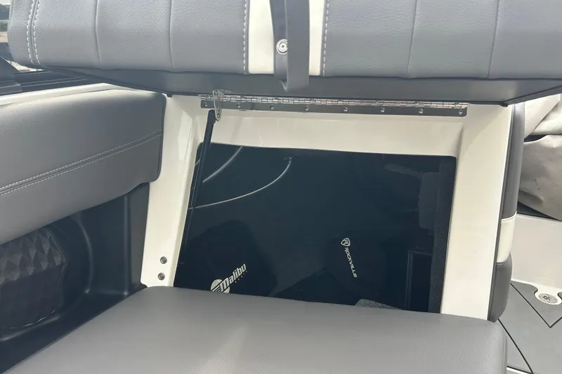 Slide: The Image of 2022 Malibu Wakesetter 23 LSV interior storage compartment with Rockville audio equipment. - 14