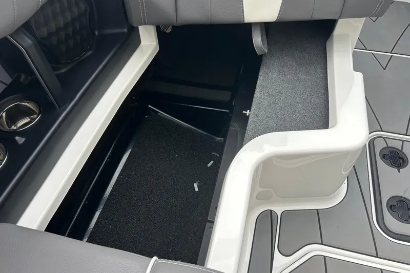 Slide: The Image of 2022 Malibu Wakesetter 23 LSV interior storage compartment with cup holders and seating. - 16