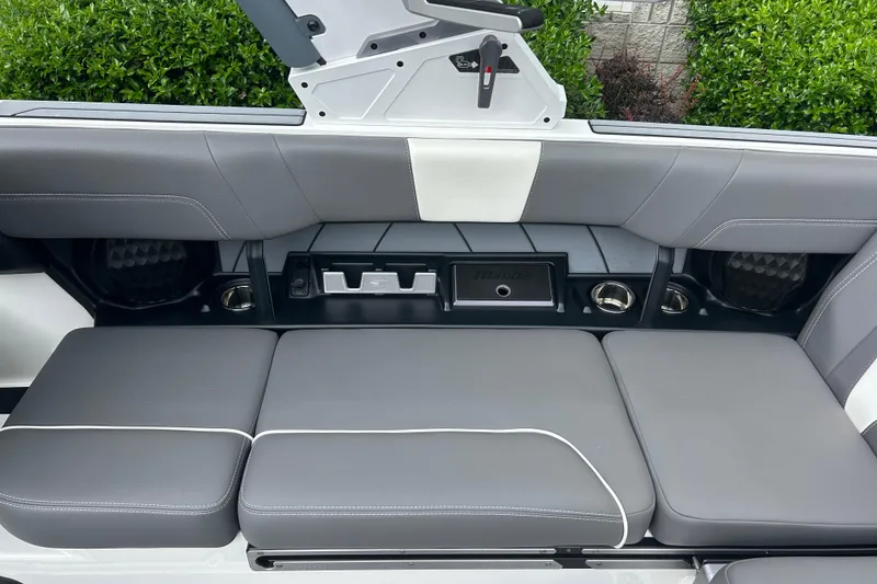 Slide: The Image of 2022 Malibu Wakesetter 23 LSV interior seating with gray upholstery and storage compartments. - 17