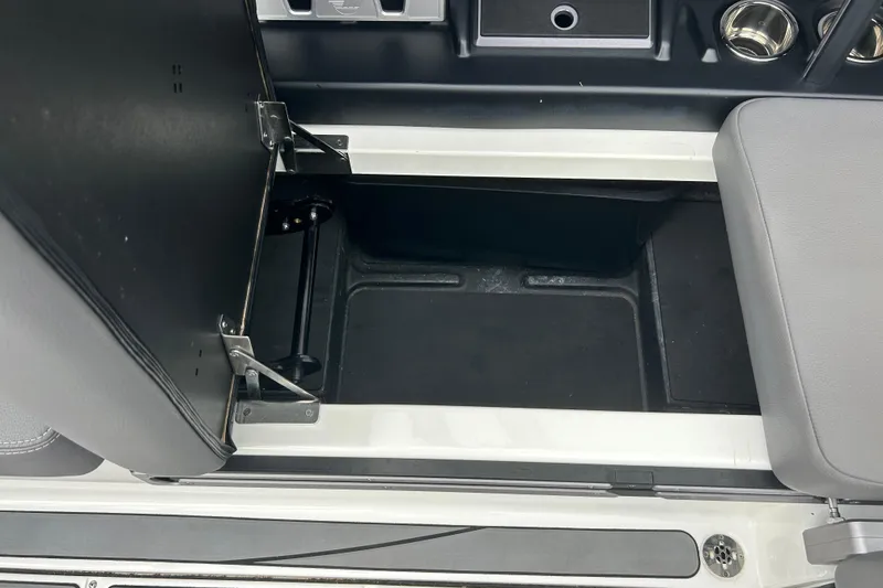 Slide: The Image of 2022 Malibu Wakesetter 23 LSV storage compartment with open lid and seating area. - 18
