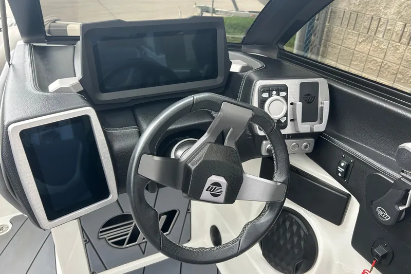 Slide: The Image of 2022 Malibu Wakesetter 23 LSV dashboard with modern steering and digital displays. - 24