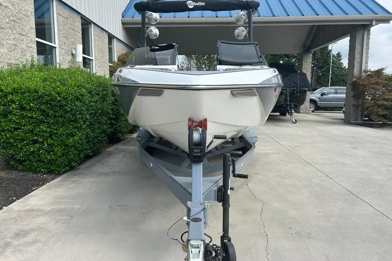 Slide: The Image of 2022 Malibu Wakesetter 23 LSV boat on trailer, parked outside a building. - 3