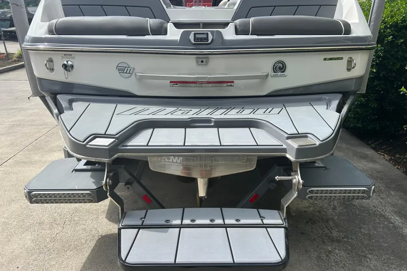Slide: The Image of 2022 Malibu Wakesetter 23 LSV boat rear view with swim platform and seating. - 5