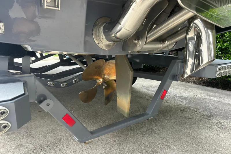 Slide: The Image of 2022 Malibu Wakesetter 23 LSV boat propeller and exhaust system on trailer. - 9
