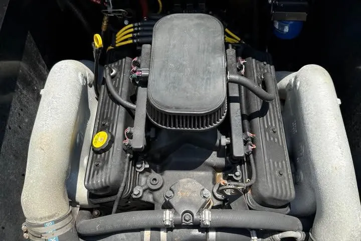 Slide: The Image of Engine of a 2011 Axis A20 boat, featuring a central air filter and visible components. - 11