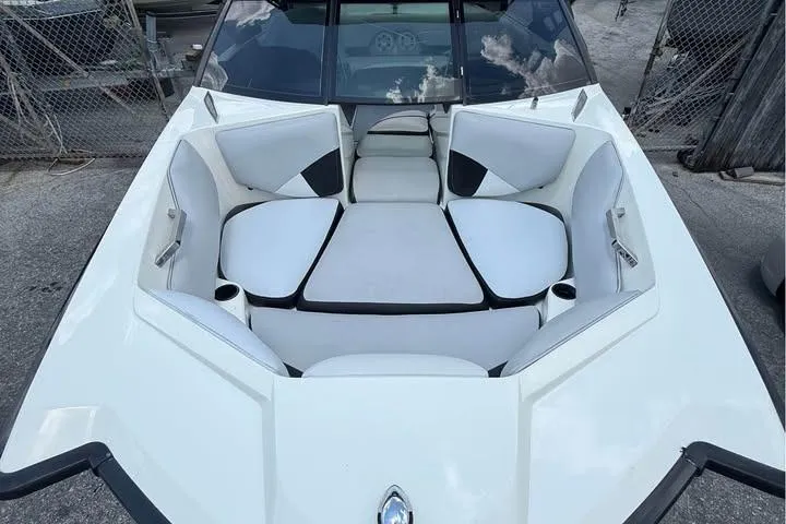 Slide: The Image of 2011 Axis A20 boat interior with white seating and cup holders. - 7
