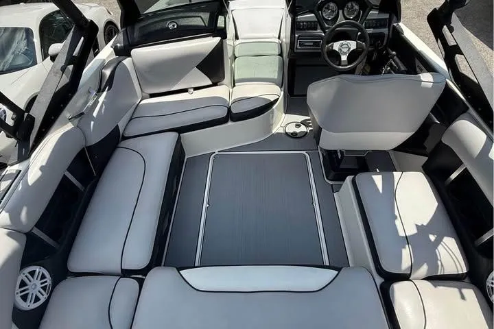 Slide: The Image of Interior of a 2011 Axis A20 boat with spacious seating and modern dashboard. - 8