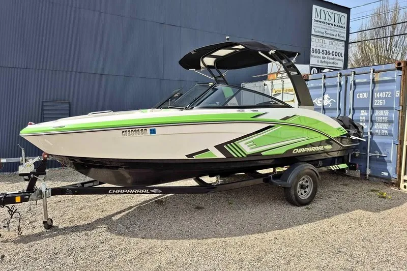 Slide: The Image of 2017 Chaparral Vortex 203 VRX boat on trailer, featuring green and white design. - 1