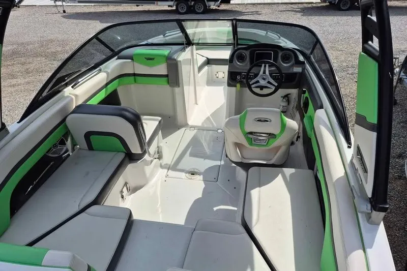 Slide: The Image of 2017 Chaparral Vortex 203 VRX boat interior with green and white seating, steering wheel, and dashboard. - 6