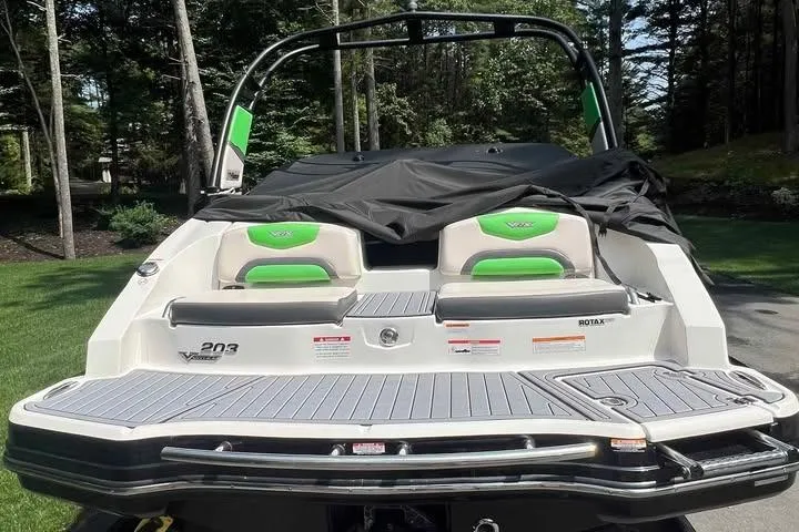 Slide: The Image of 2017 Chaparral Vortex 203 VRX boat with green accents, rear view in a wooded area. - 9