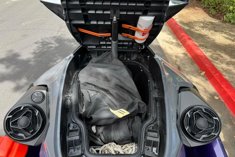 Slide: The Image of Open storage compartment of a 2021 Sea-Doo RXT-X 300 with gear inside. - 12