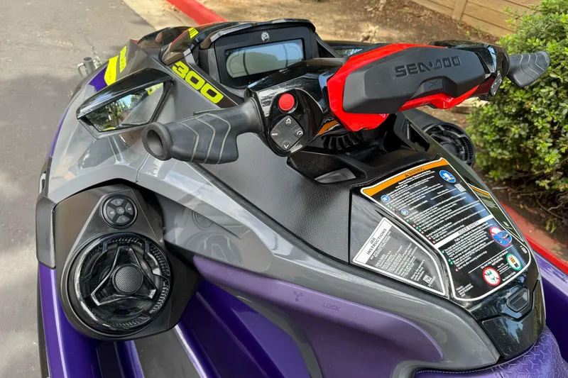 Slide: The Image of 2021 Sea-Doo RXT-X 300 jet ski handlebars and controls, featuring vibrant design and detailed instructions. - 5