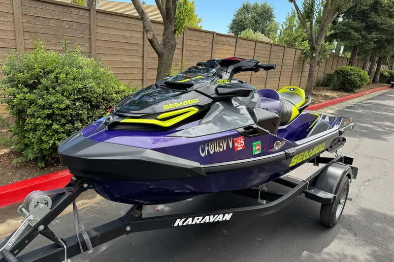 Slide: The Image of 2021 Sea-Doo RXT-X 300 jet ski on trailer, parked on a street. - 6