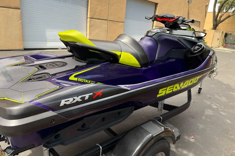 Slide: The Image of 2021 Sea-Doo RXT-X 300 jet ski in vibrant colors on a trailer. - 8