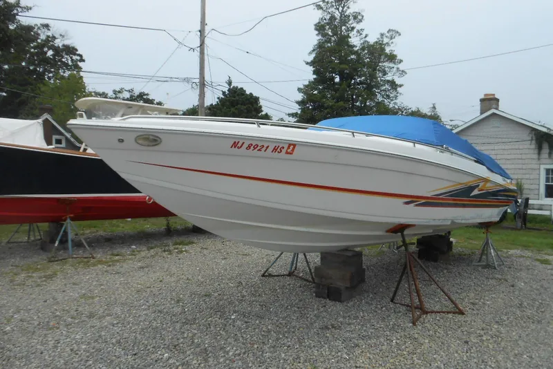 The Image of 2003 Formula 271 FASTech boat with blue cover, parked on gravel. - 0
