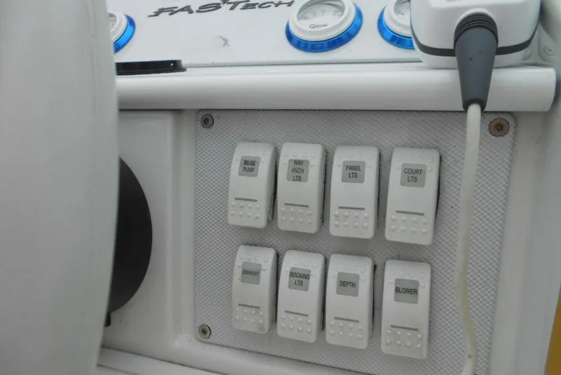 Slide: The Image of Control panel of a 2003 Formula 271 FASTech boat with labeled switches. - 11