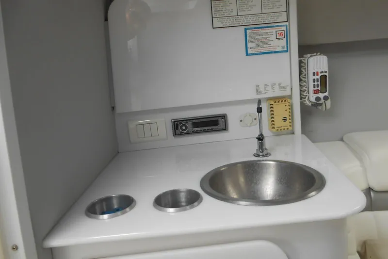 Slide: The Image of Interior of 2003 Formula 271 FASTech boat featuring a compact sink and control panel. - 14