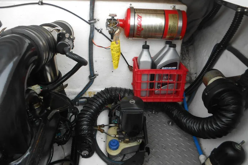 Slide: The Image of Engine compartment of 2003 Formula 271 FASTech with fire extinguisher and oil containers. - 24