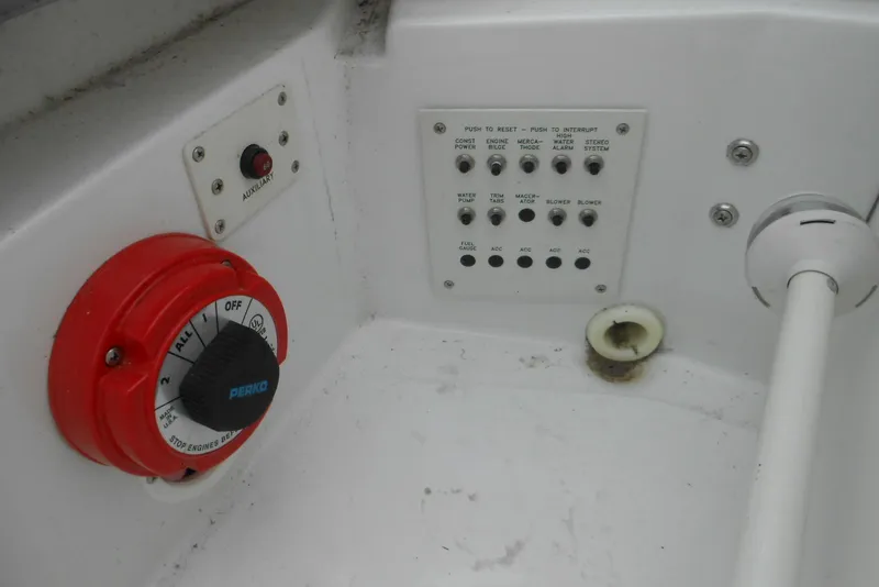 Slide: The Image of Control panel of a 2003 Formula 271 FASTech boat with switches and a red Perko dial. - 25