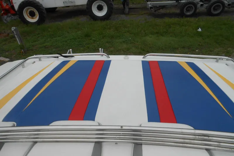 Slide: The Image of 2003 Formula 271 FASTech boat with colorful deck design featuring blue, red, and yellow stripes. - 5