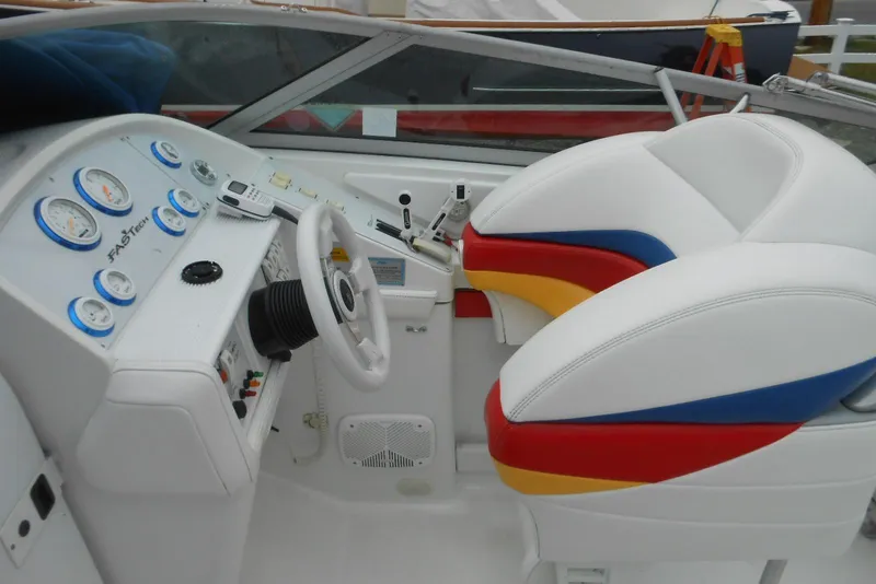 Slide: The Image of 2003 Formula 271 FASTech boat cockpit with colorful seats and detailed dashboard controls. - 6