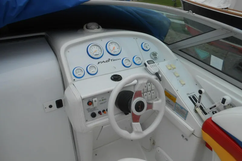 Slide: The Image of 2003 Formula 271 FASTech boat dashboard with gauges and steering wheel. - 7