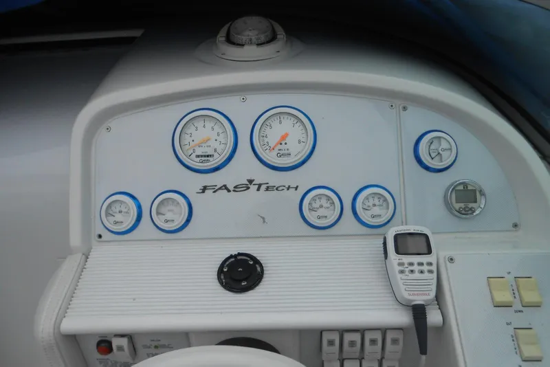 Slide: The Image of Dashboard of a 2003 Formula 271 FASTech boat with gauges and controls. - 8