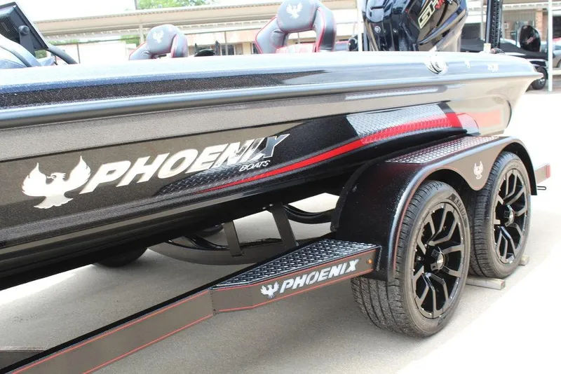 Slide: The Image of 2026 Phoenix 21 XE boat with sleek black design and custom wheels. - 11