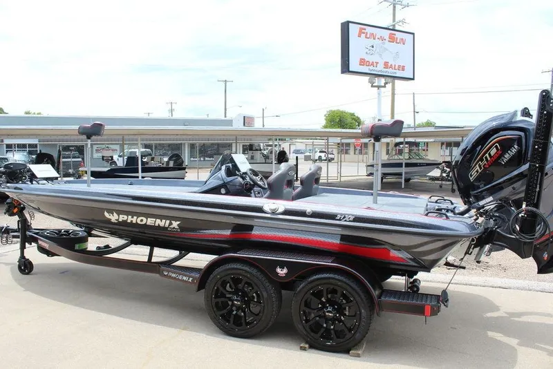 Slide: The Image of 2026 Phoenix 21 XE boat at dealership, featuring sleek design and powerful engine. - 12