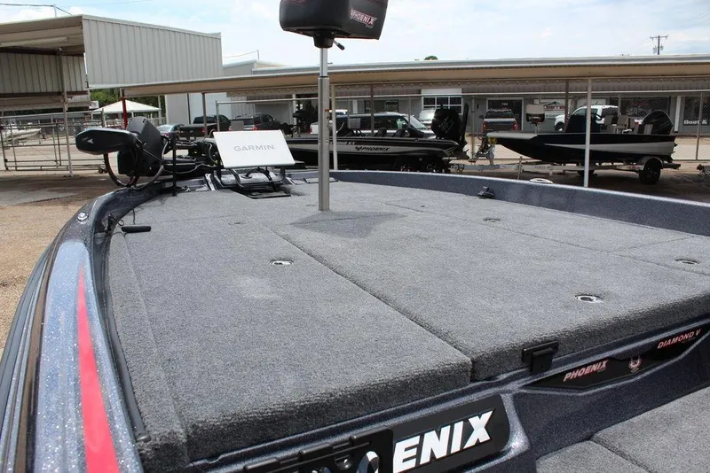 Slide: The Image of 2026 Phoenix 21 XE boat deck with Garmin equipment, parked in a marina. - 13